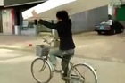 Man delivers mattress on bicycle.
